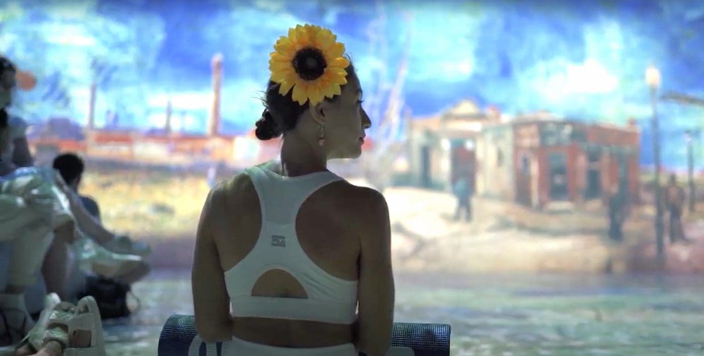 Woman with sunflower in her hair at Happy Munkey x Immersive Van Gogh Exhibit After Hours
